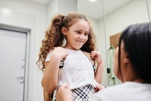 Mother prepares child for school