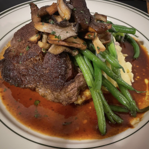 Porcini dusted filet mignon, Yukon gold potato purée, haricot vert, with mixed wild mushrooms & a red wine Demi-glacé.