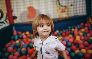 a happy boy in a playpen