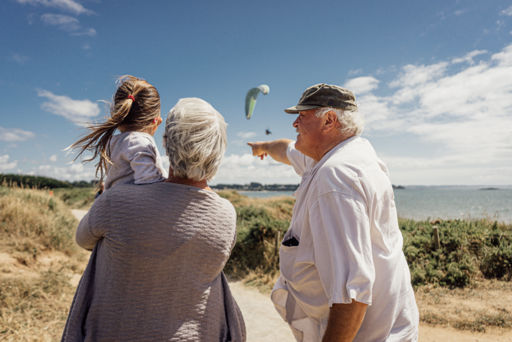 grandparents taking a walk with their granddaughter